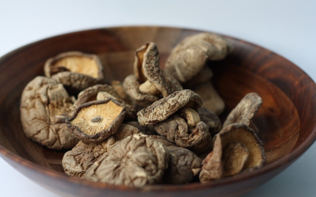 A wooden bowl of immune boosting dried shiitake mushrooms